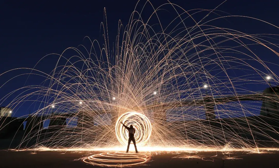 A person surrounded by arcs of light, symbolising personal transformation