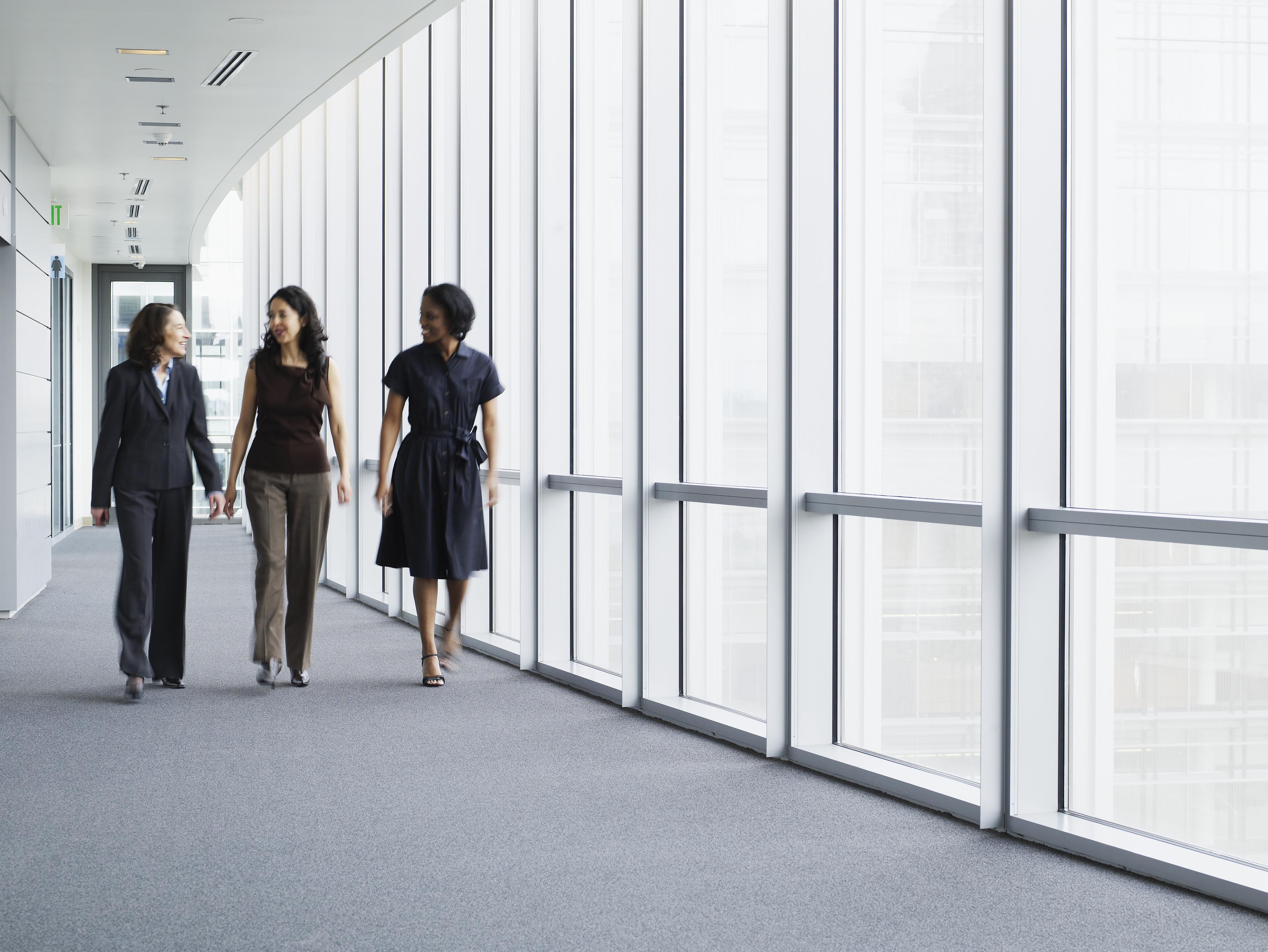Professionals walking together at work